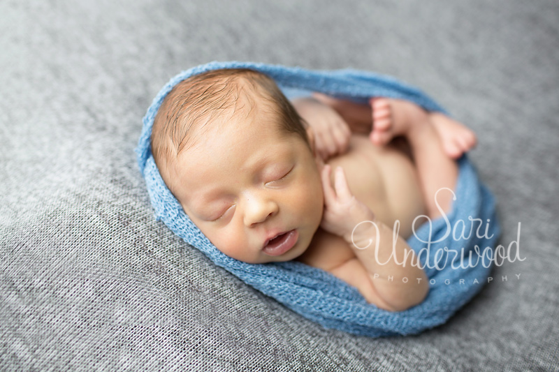 23 day old baby boy in a blue wrap