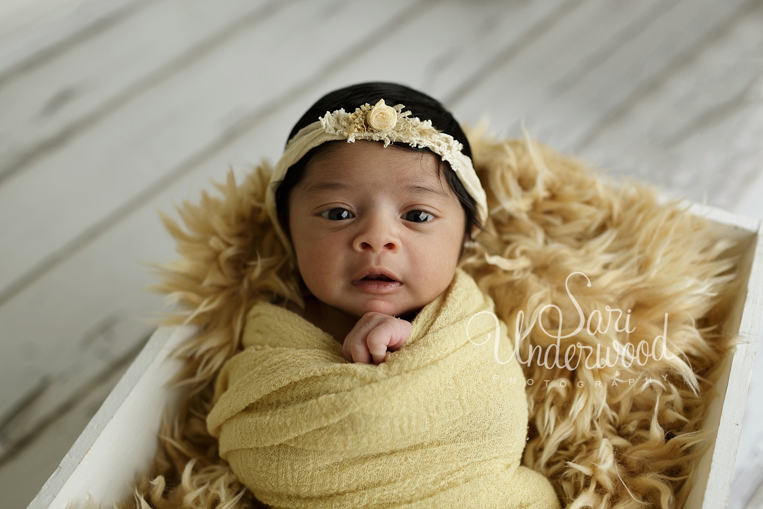 brunette newborn baby girl in yellow