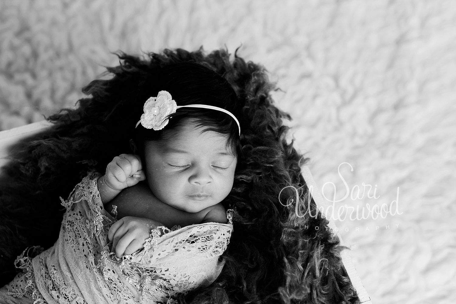 Black and White photo of baby girl in a basket