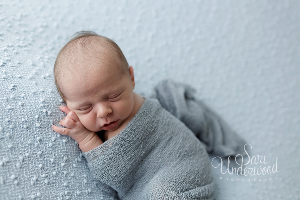 baby boy in light blue wrap