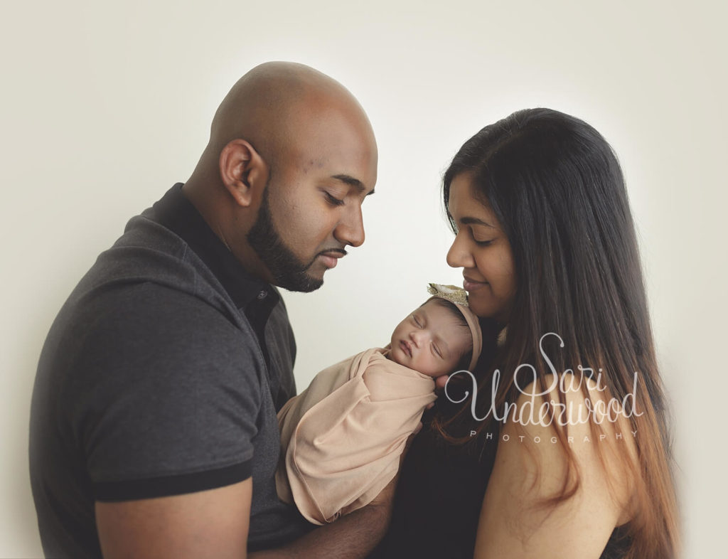 family of color with brand new baby girl