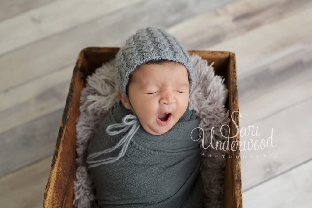 newborn baby boy yawning