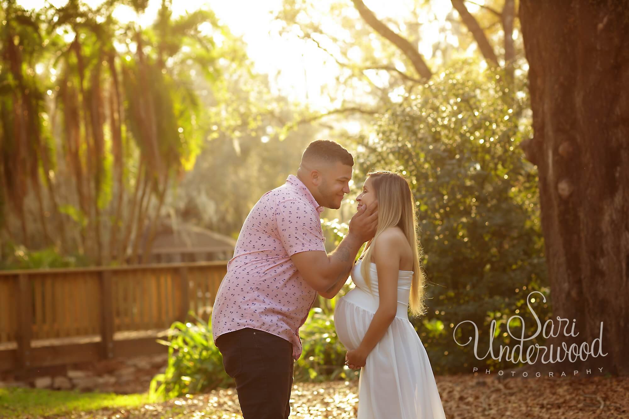 expectant parents in golden light