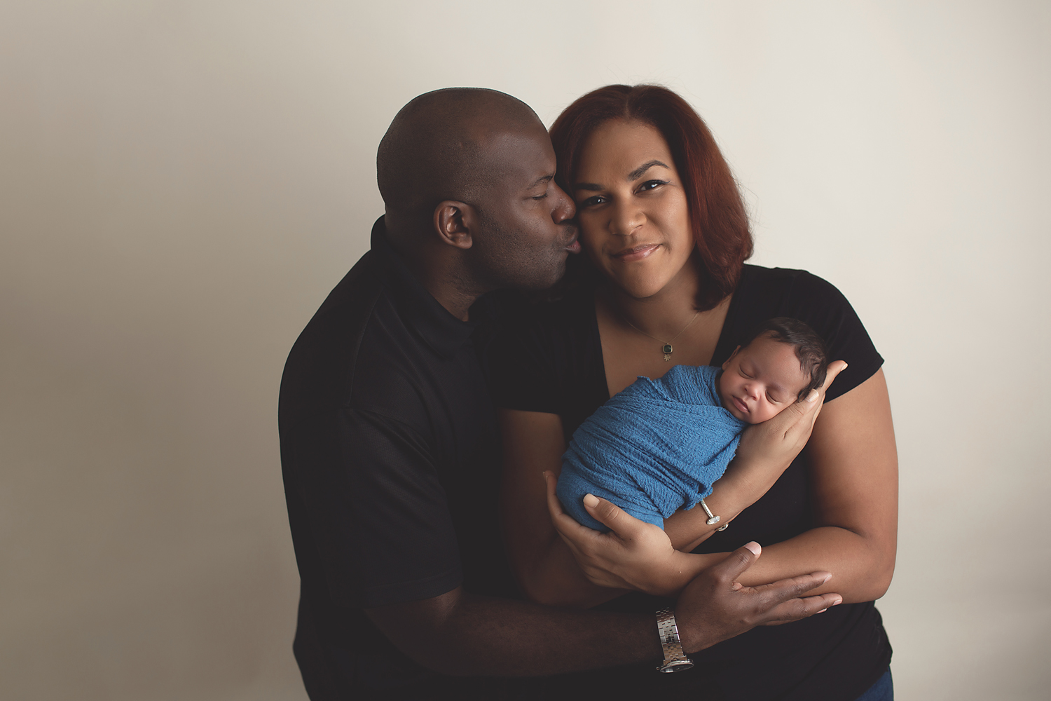 african american family holding newborn baby boy