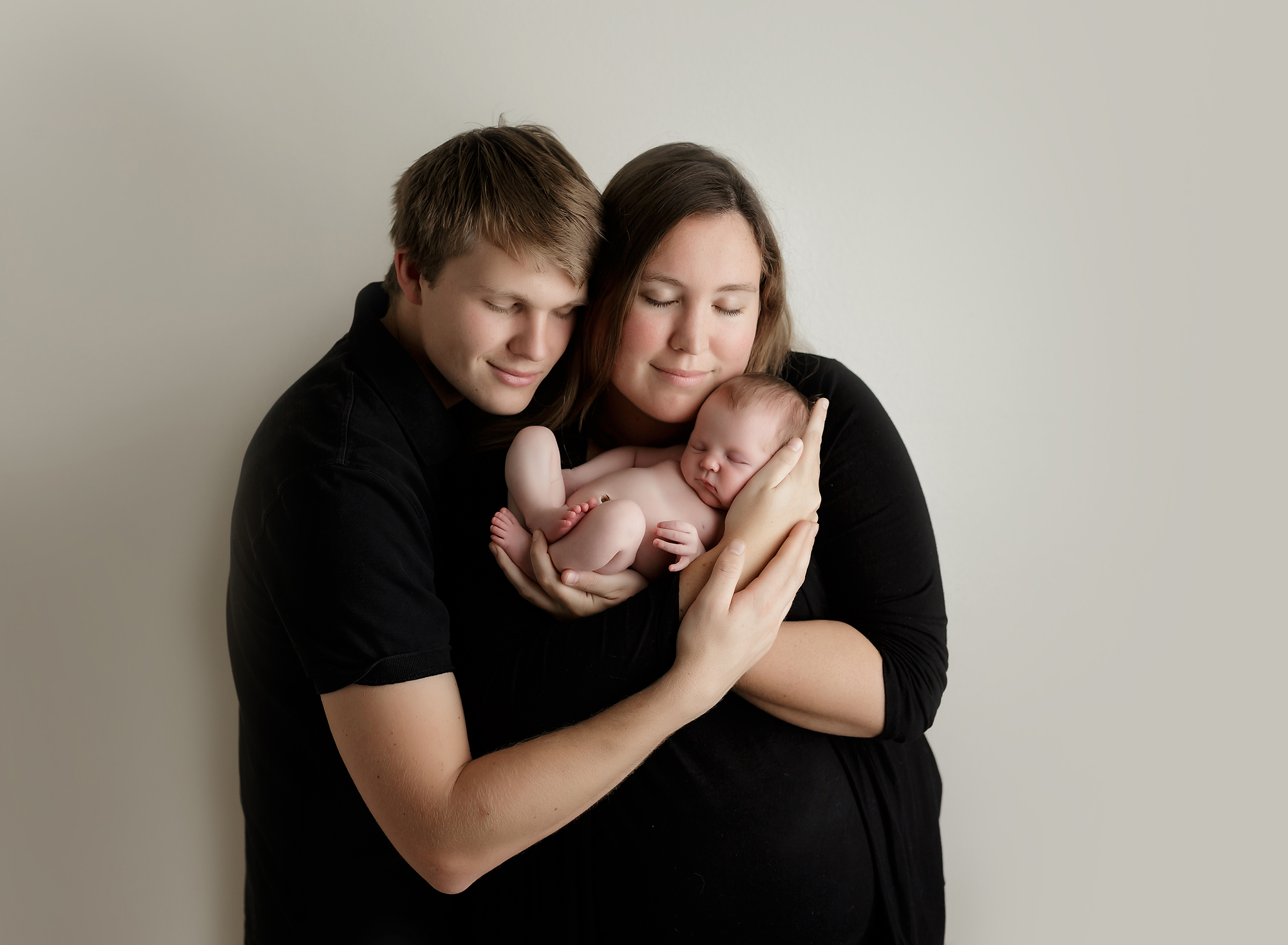 parents holding newborn baby boy