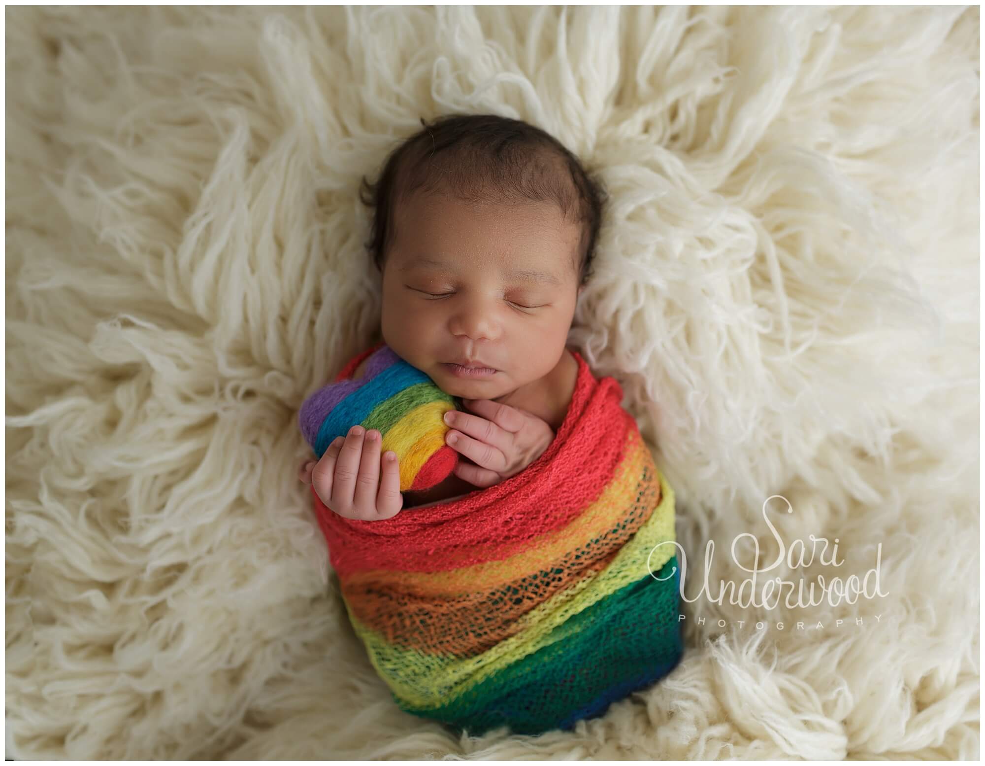 rainbow baby in rainbow swaddle